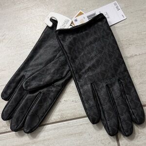 Michael Kors black Patterned ladies Gloves. NWT
Touch tip.. size M